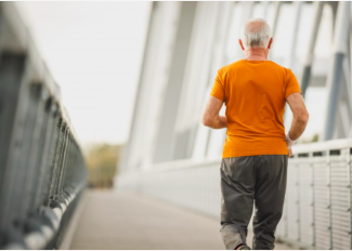 The back of a senior running on a bridge