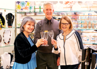 three residents toast with empty glasses in the Carousel