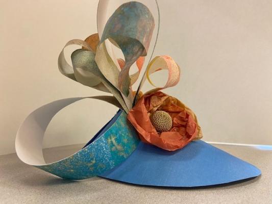 Paper fascinator with colorful paper and embellishments