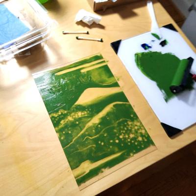 Green mountain scene painted on a sheet of plexi glass with printmaking ink