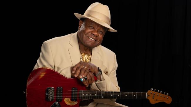Norman Sylvester with his guitar.