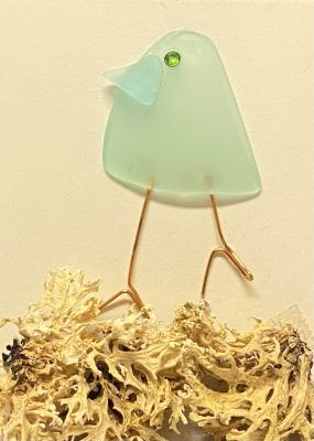 a small bird made from sea glass and wire