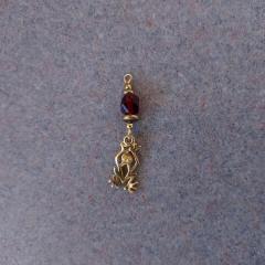 Gold Earring with red bead found in the Manor Library.
