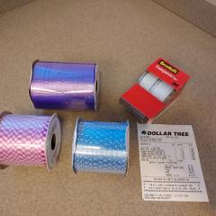 3 rolls of ribbon and a pack of tape found at the bag donation bin at the Manor.