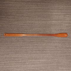 Wooden extended shoe horn found in guest room 401C.