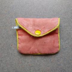 Pink and yellow coin purse found by the Manor US mailboxes.