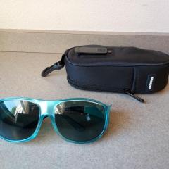 Cocoons blue rimmed sunglasses and black carrying case.