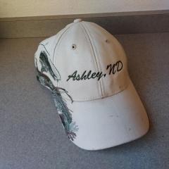 Ashley, ND baseball cap with fly fishing design on the side.