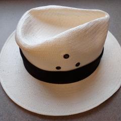 Peter Grimm panama cream hat with black band found in the gated lot.