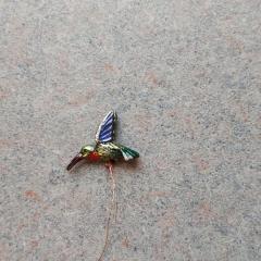 Small metal hummingbird found in the Manor parking lot.