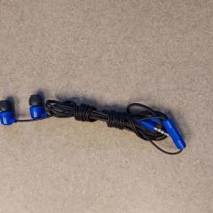 Blue and black ear buds found on the Manor Reception counter.