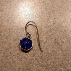 Earring: Silver hexagon with navy stone found in Manor hallway.