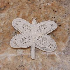 Cream crocheted butterfly found in elevator A.