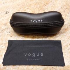 Black Vogue glasses case with zipper close and cloth cleaner found in the Manor Library.