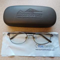 Black metal rimmed men's glasses with black Bridge City Spex glasses case and cleaning cloth found at North Point.