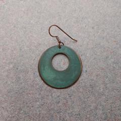 Round metal patina color earring found outside the Blue Heron Auditorium.