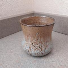 Light brown and green ceramic bowl found on top of the Manor shredder.