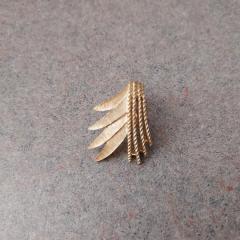 Gold clasp earring found by the Manor Library fireplace.