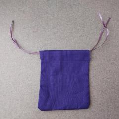 Small purple cloth gift bag with tie top.