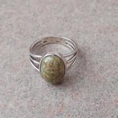 Silver ring with oval green/pink/white stone found in the Manor 3rd floor storage room.