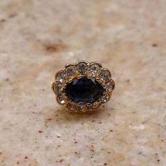 Oval stud earring with blue center stone surrounded by diamonds left at Terrace Reception Desk.