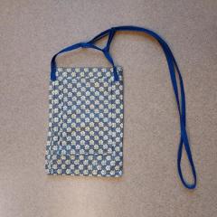 Small blue floral purse with solid blue strap.