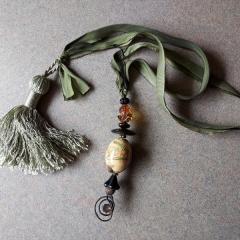 Tassel with ribbon and beads found on a shopping cart (lower level by the Mart).