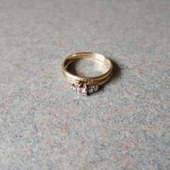 Diamond wedding ring (with 5 diamonds) and attached gold band found in the Carousel.