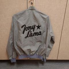Men's grey jacket with black Tony Lama wording found in the Terrace.