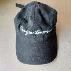 Black baseball cap with "Open your tomorrow" embroidery.