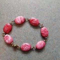 Bracelet with pink oval stones and diamonds in between.