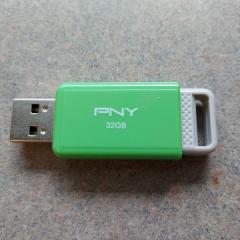 Green and grey thumb drive with PNY on the side found in the Manor resident copy machine.