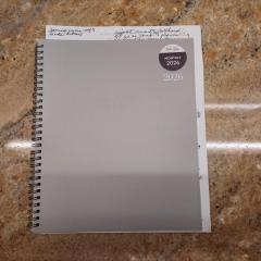 Light grey 2026 planner/calendar found in the Terrace 2nd floor women's bathroom.