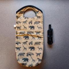 Safari theme wine bottle carrier and wine key found in the Blue Heron Auditorium.