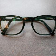 "Coast" dark green and black reading glasses left at the Terrace desk.