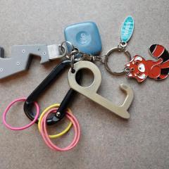 Carabiner with multiple attachments: bottle opener, tile, Boise Zoo, Ikea & rubber bands.
