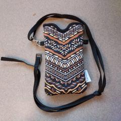 Small multicolored women's purse with long black strap found in the Art Room.
