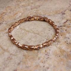 Rose gold colored link bracelet with gems found at the loading dock.