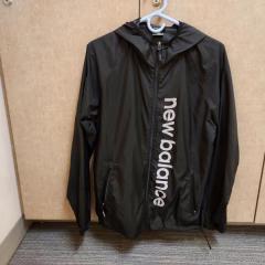 Black New Balance zip up light weight jacket found in the fitness center.