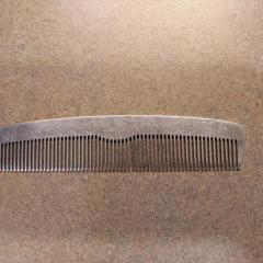 Silver metal comb found in the Manor parking lot.