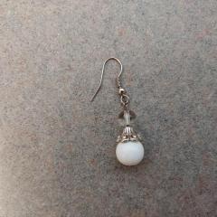 Silver drop earring with clear and white beads found in Riverview restaurant. 