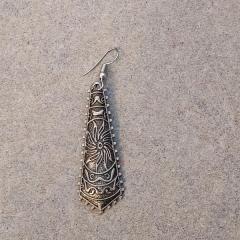Long silver earring with sun motif found by the train in the Court building.