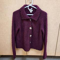 Purple sweater/cardigan with black trim by "River" found in the Terrace.