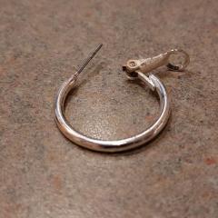 Silver hoop earring found near bench in front of the Manor.