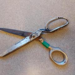 Large, heavily worn silver scissors found near the Plaza puzzle table.