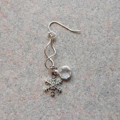 Silver snowflake and gem stone earring found in the Central Garage.