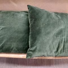 Two large dark green square pillows found in the Blue Heron Auditorium.