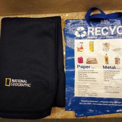 Blue "Recycle" bag and fleece black blanket (national geographic logo) found in the Blue Heron Auditorium.