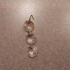 Three clear round plastic gems attached/hanging left at Manor Reception.