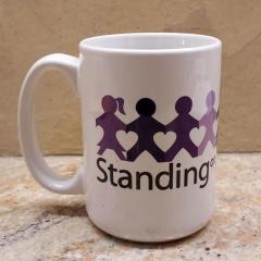 White mug (and teabags) with purple kids and "Standing on the side of love" wording, found in the Manor inner vestibule.